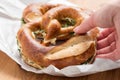 Woman eating German Brezel pretzel with chives and butter