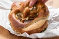 Woman eating German Brezel pretzel with chives and butter