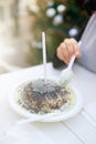 Woman eating germknodel at christmas food stand.