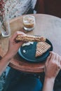 Woman eating grill sandwich ham cheese and salad  lettuce, ham, cheese, tomato and potato chipwith a cup of coffee for Breakfast Royalty Free Stock Photo