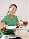Woman eating healthy lunch while reading magazine Royalty Free Stock Photo