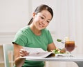 Woman eating healthy lunch while reading magazine Royalty Free Stock Photo