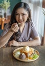 Woman eating honey toast, sweet dessert in cafe Royalty Free Stock Photo