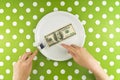 Woman eating hundred dollar bill for dinner Royalty Free Stock Photo