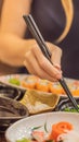 Woman eating japanese food in a japanese food restaurant VERTICAL FORMAT for Instagram mobile story or stories size Royalty Free Stock Photo