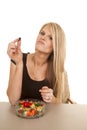 Woman eating jelly beans hold black one