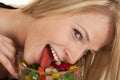 Woman eating jellybeans lick in bowl