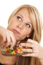 Woman eating jellybeans look up