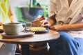 Woman eating lemom pie tart cake with coffee on table. Royalty Free Stock Photo