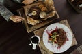 Woman eating meat steak with vegetables in a restaurant. Lunch time. The concept of a healthy dinner. Top view of the dining table