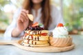 A woman eating a mixed berries pancakes with ice cream and whipped cream Royalty Free Stock Photo
