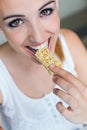 Woman eating muesli bar snack. Royalty Free Stock Photo