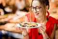 Woman eating mussels at the food market