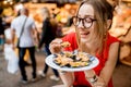 Woman eating mussels at the food market