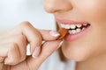 Woman Eating Nuts. Closeup Of Female Mouth Biting Nut.