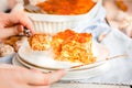 Woman eating piece of tasty hot lasagna served on a white plate. Italian cuisine, menu, recipe. Homemade meat lasagna. Close up, Royalty Free Stock Photo