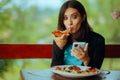 Woman Eating a Pizza while Checking her Phone Royalty Free Stock Photo