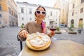 Woman eating pizza at italian restaurant outdoors Royalty Free Stock Photo