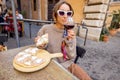 Woman eating pizza at italian restaurant outdoors Royalty Free Stock Photo