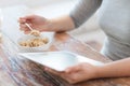 Woman eating porridge and using tablet pc Royalty Free Stock Photo