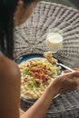 Woman eating potato dumplings with sheep cheese and bacon, traditional slovakian food, slovak gastronomy