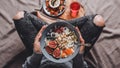 Woman eating Rice coconut porridge with figs, berries, nuts and coconut milk in plate. Healthy breakfast ingredients. Royalty Free Stock Photo