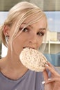 Woman eating rice cracker Royalty Free Stock Photo