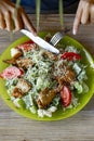 Woman eating salad with grilled chicken breast with vegetables and herbs Royalty Free Stock Photo