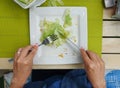 A woman is eating a salad from a white plate, top view Royalty Free Stock Photo