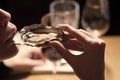 Woman eating shellfish. Seafood and Mediterranean cuisine with mussels in shell. Young woman eating oyster in luxury Royalty Free Stock Photo