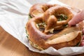 Woman eating German Brezel pretzel with chives and butter