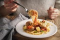 Woman eating spaghetti with meatballs and cheese Royalty Free Stock Photo