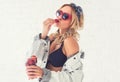 Woman eating strawberries looking to the side wearing sunglasses heart shape in lingerie and jeans jacket Beautiful Royalty Free Stock Photo