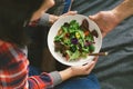 Woman eating summer salad vegetables flowers nasturtium violets