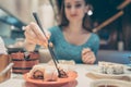 Woman eating sushi food in Japanese restaurant