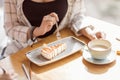 Woman eating sweet dessert while sitting in cafe, coffee break