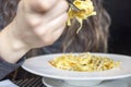 Woman eating tagliatelle pasta with vegetable sauce Royalty Free Stock Photo