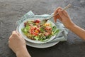 Woman eating tasty quinoa salad at table, closeup Royalty Free Stock Photo