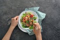 Woman eating tasty quinoa salad at table, closeup Royalty Free Stock Photo