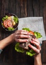 Woman eating tasty unhealthy burger twisted sandwich in hands Royalty Free Stock Photo