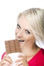 Woman eating a tempting bar of chocolate Royalty Free Stock Photo