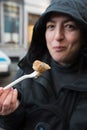 Woman eating Thai spring rolls