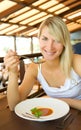 Woman eating tomato soup