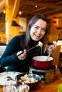 Woman eating tradicional Swiss dish - fondue Royalty Free Stock Photo