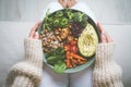 Woman eating vegan or vegetarian meal. Buddha vegan bowl with fresh vegetables. Vegan food plate. Healthy eating Royalty Free Stock Photo