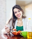 Woman eating veggie salad with spoon