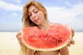 Woman eating watermelon on the beach Royalty Free Stock Photo