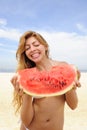 Woman eating watermelon on the beach Royalty Free Stock Photo