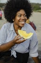 Woman eating a watermelon at a beach picnic Royalty Free Stock Photo