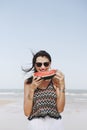 Woman eating watermelon at the beach Royalty Free Stock Photo